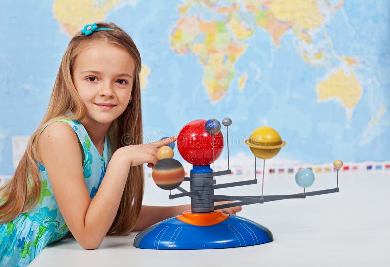 Young girl study solar system in science class stock photo Young girl study solar system in science class stock photo