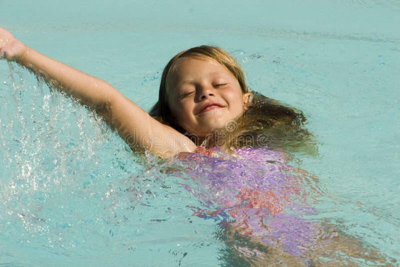 Young girl swimming in pool