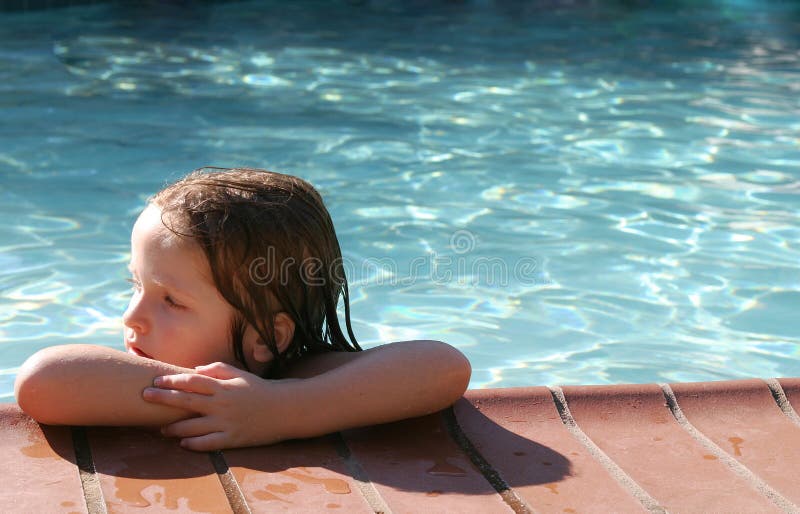 Young girl learning how to swim using a float. Young girl learning how to swim using a float