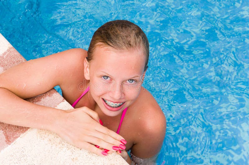 Young smiling girl in the swimming pool. Young smiling girl in the swimming pool.