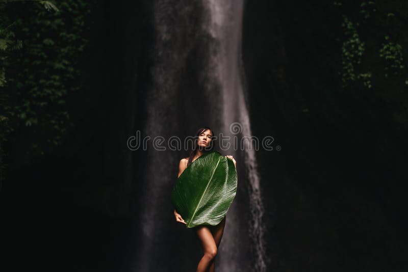 Young and beautiful girl taking bath in a waterfall. Young and beautiful girl taking bath in a waterfall