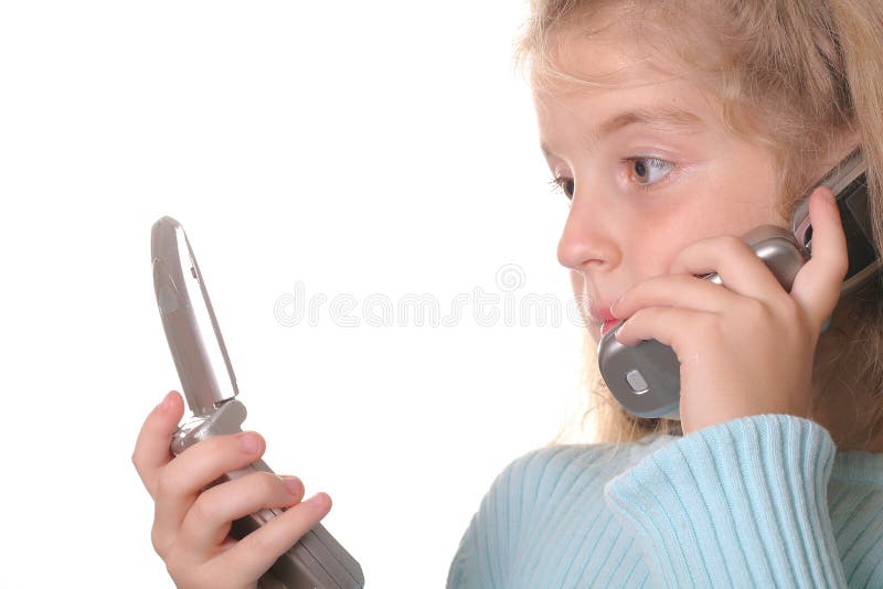 Young girl talking on a cell phone looking at anot