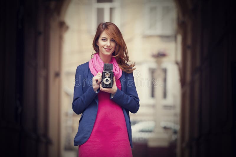 Young girl with vintage 6x6 camera at outdoor.