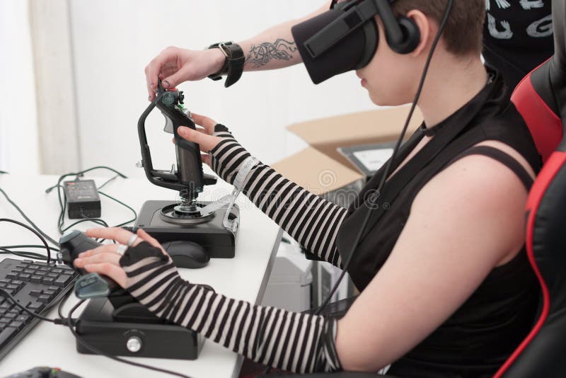 Young girl with VR - glasses plays game on PC at Animefest stock photography Young girl with VR - glasses plays game on PC at Animefest stock photography