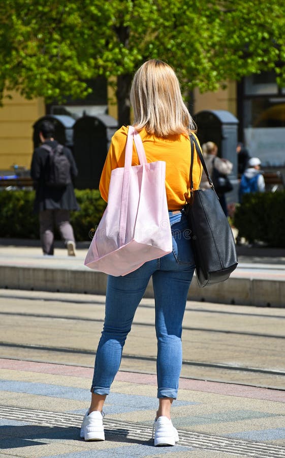Gorgeous young lady with perfect butt waiting the bus
