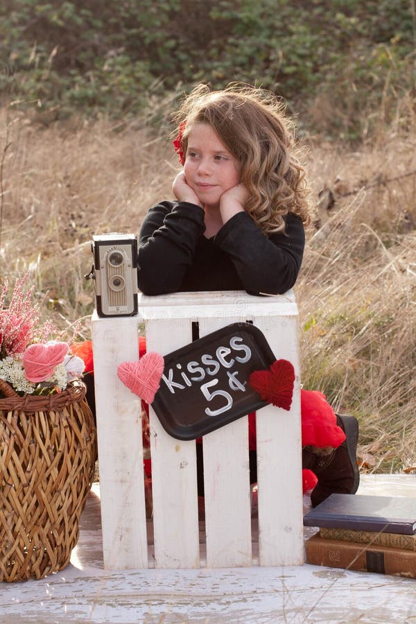 Young girl waiting at kissing stand