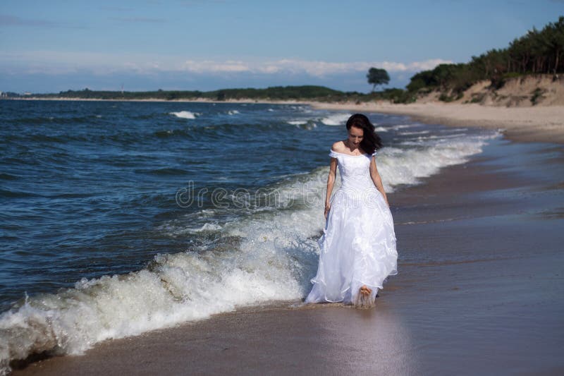 Young girl walking along the seashore