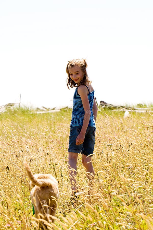 Young Girl Walking Her Dog through a Field Grass Stock Image Image of