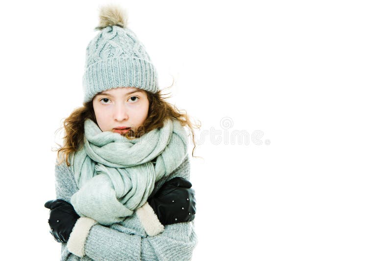 Young girl warming herself by wearing winter cap, gloves stock photography Young girl warming herself by wearing winter cap, gloves stock photography