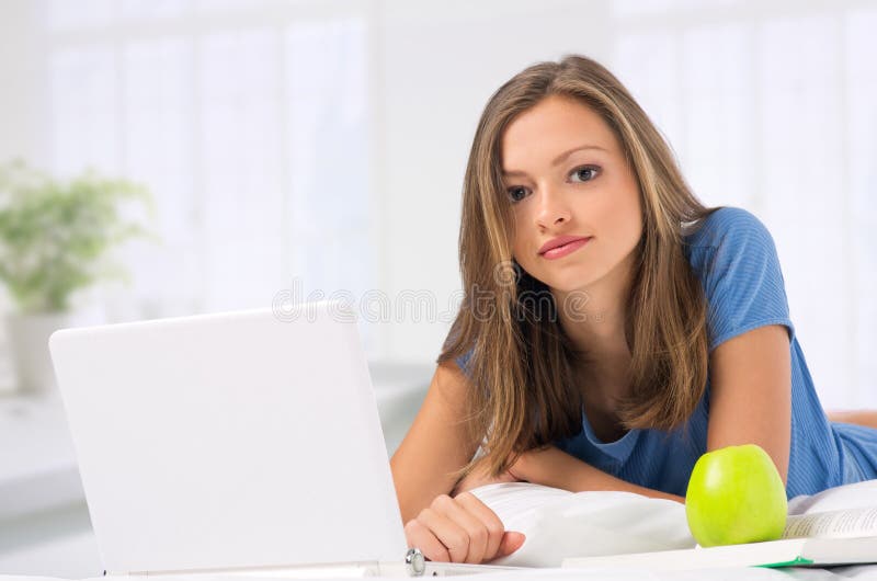 Young girl working with laptop at home