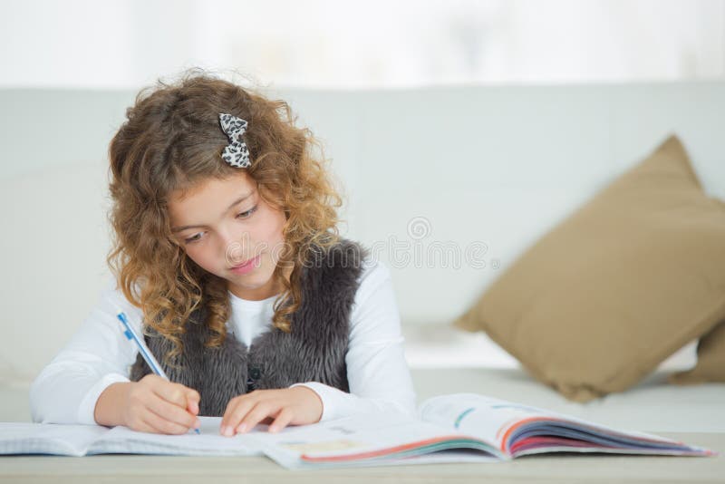 Young girl writing into notebook royalty free stock photo