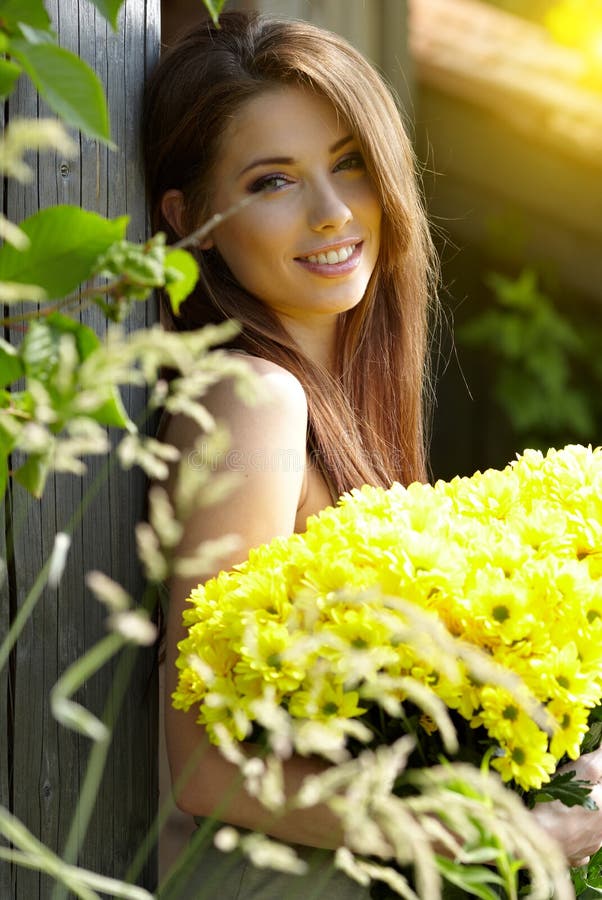 Young girl with yellow flowers