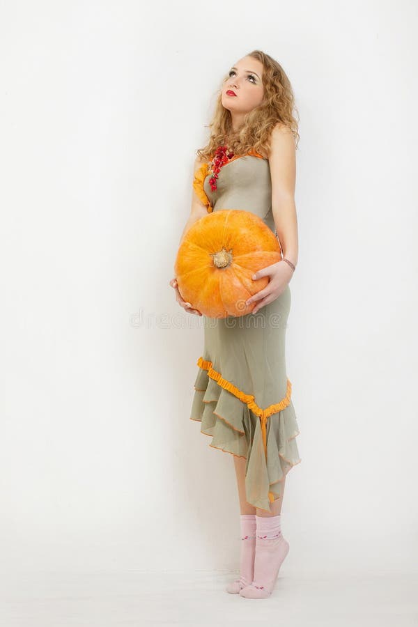 Young girl with a yellow pumpkin