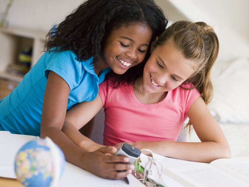 Young Girls Distracted From Their Homework