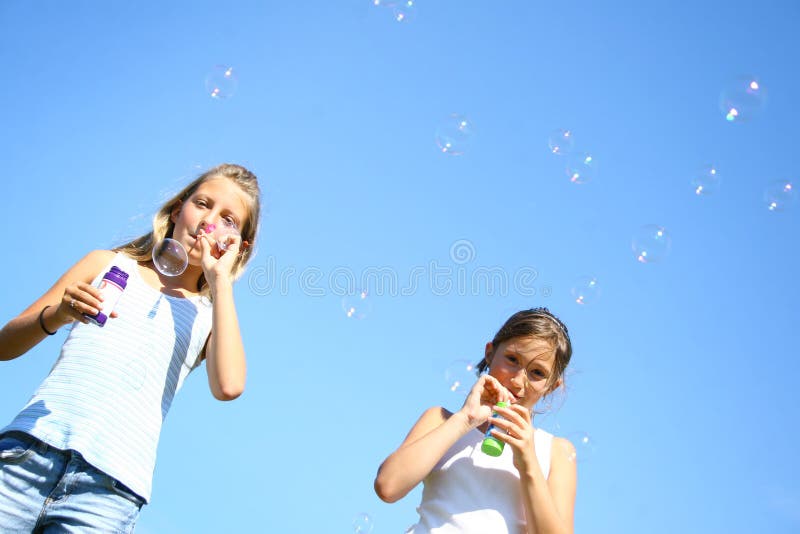 Young girls doing bubbles