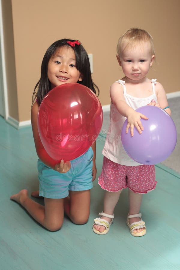 Young girls holding balloons