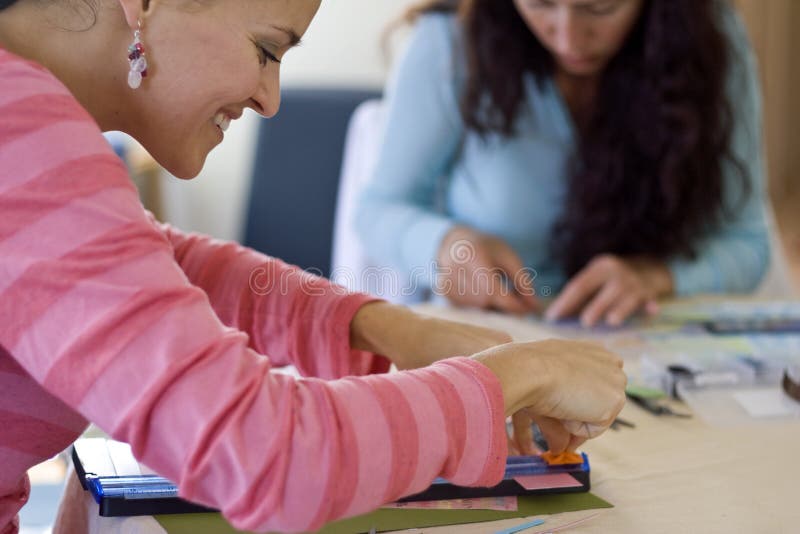 Young girls making Scrapbook