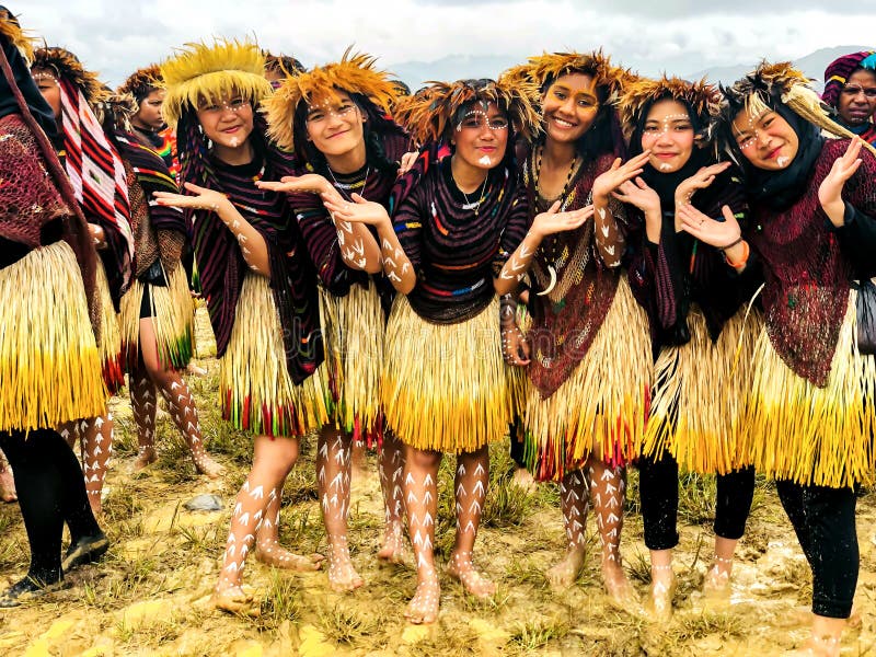 Young girls of a papuan tribe in a beautiful crown from bird feathers