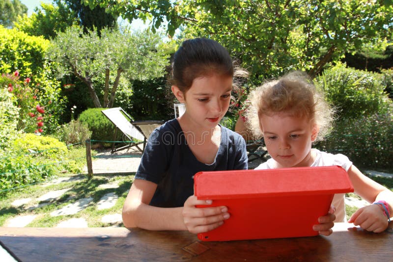 Young girls and a PC tablet stock photos