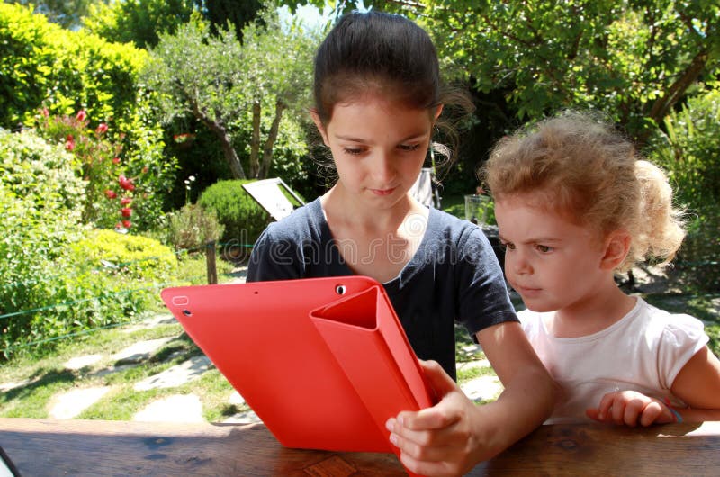 Young girls and a PC tablet royalty free stock photos