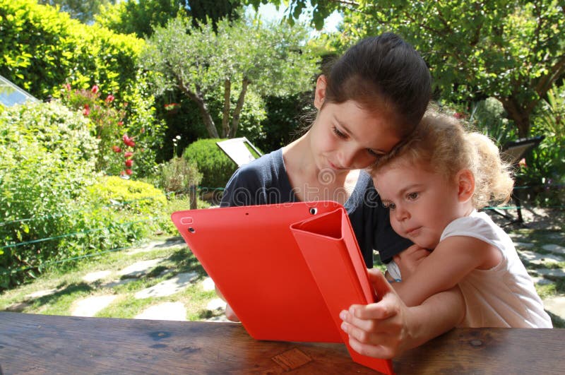 Young girls and a PC tablet stock photography