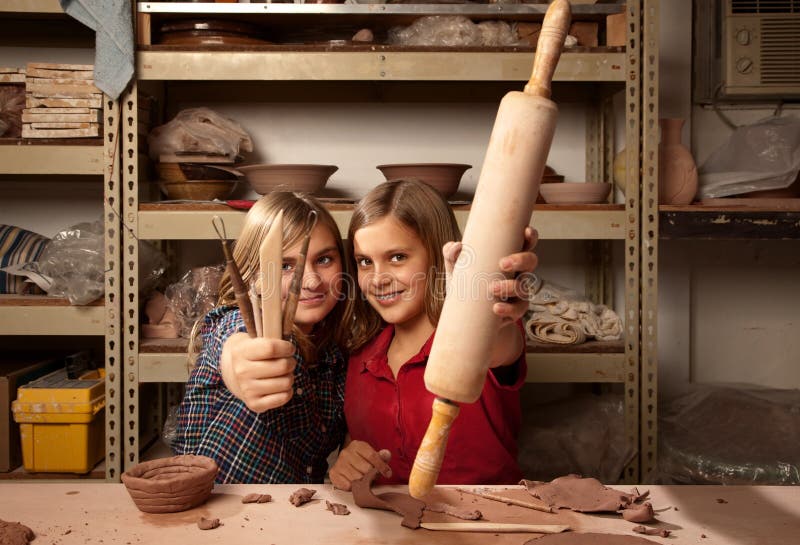 Young girls with tools in clay studio