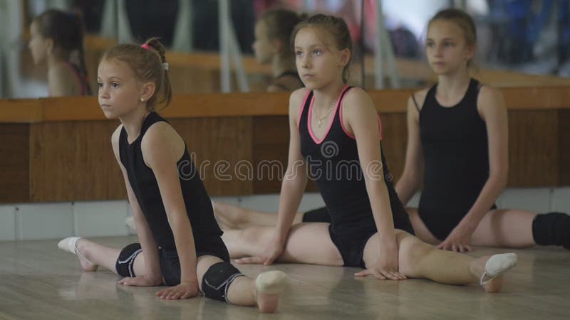 Young Girls Warm Up in the Gym. the Exercises in Rhythmic Gymnastics. Stock Footage - Video of activity, athletics: 75109528