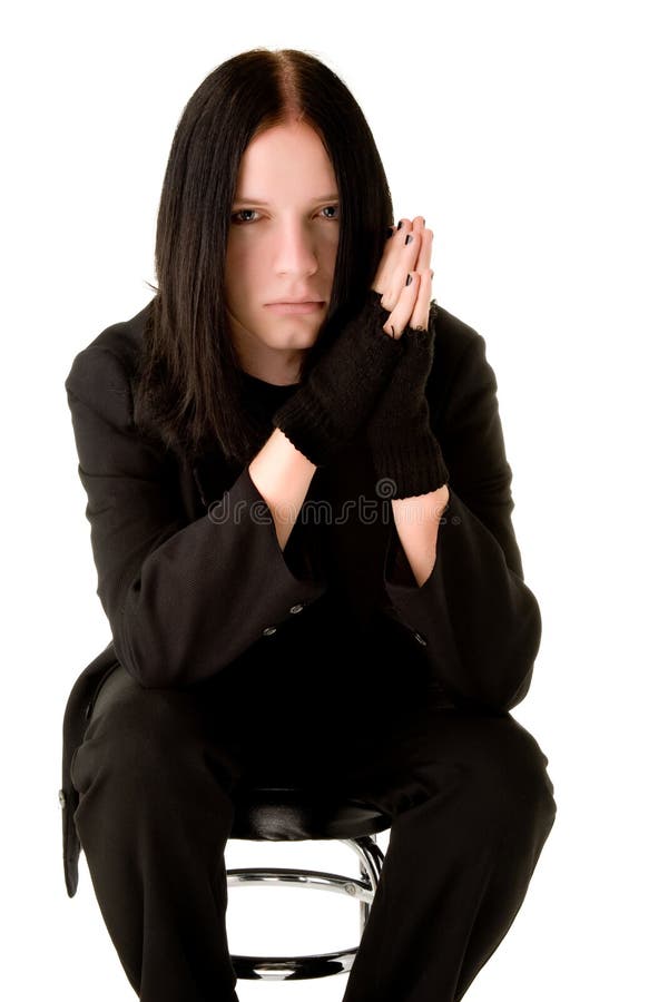 Young goth sitting on a bar chair
