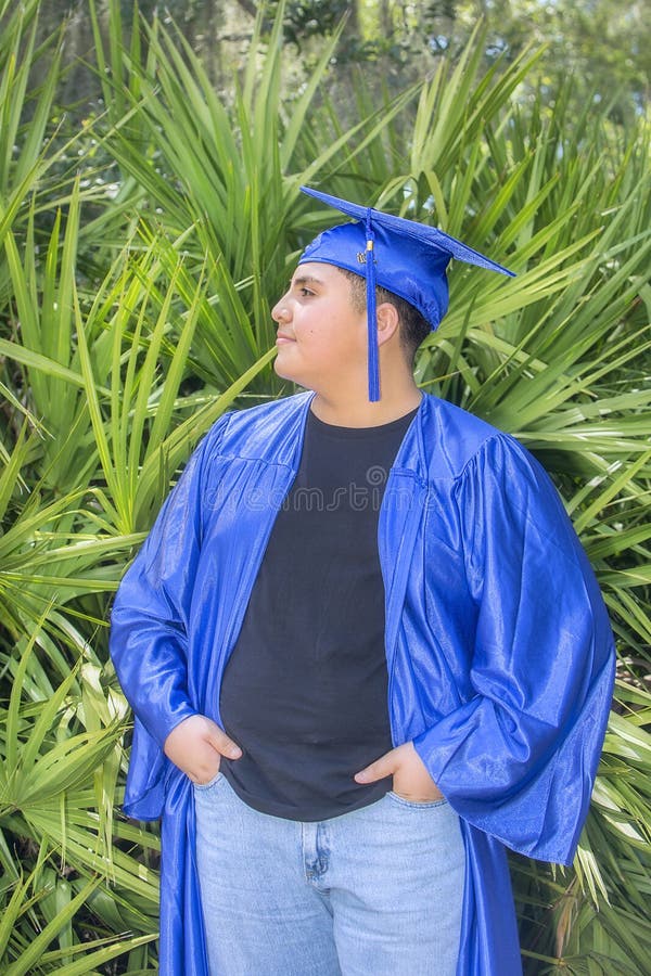 Young Graduate Proudly Displaying Cap And Gown royalty free stock images Young Graduate Proudly Displaying Cap And Gown royalty free stock images