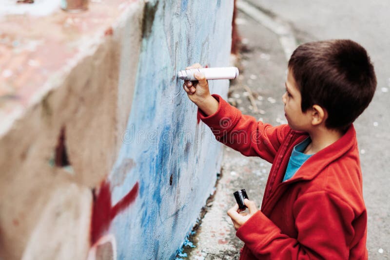 Kid painting graffiti stock image. Image of youth, graffiti 63854113