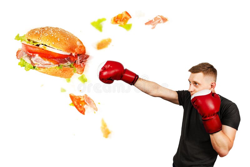 A young guy kick hamburger . The concept is the fight against unhealthy fast food