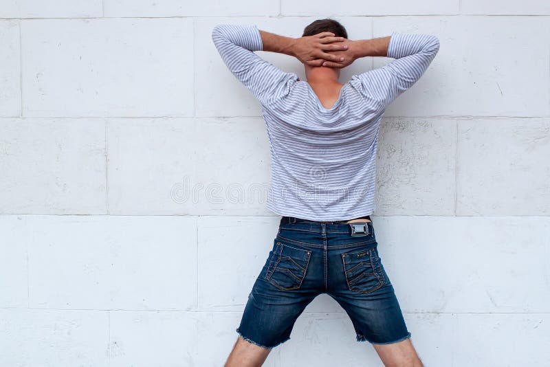 Guy Put Hands Behind Head. Isolated Back Faced Portrait on White