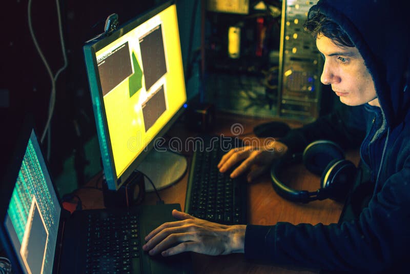 Young hacker in the dark infect computers and systems royalty free stock images Young hacker in the dark infect computers and systems royalty free stock images