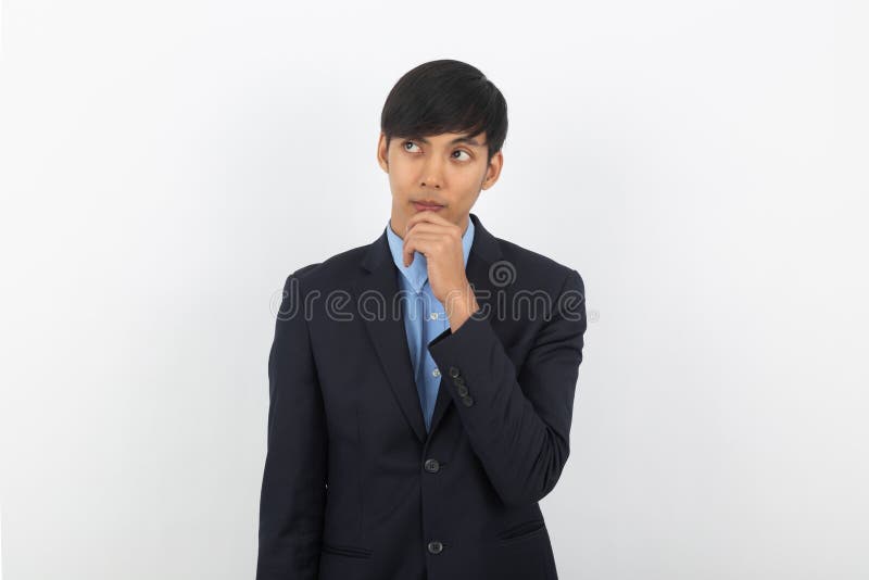 Young handsome asian business man thinking an idea while looking up isolated on white background.