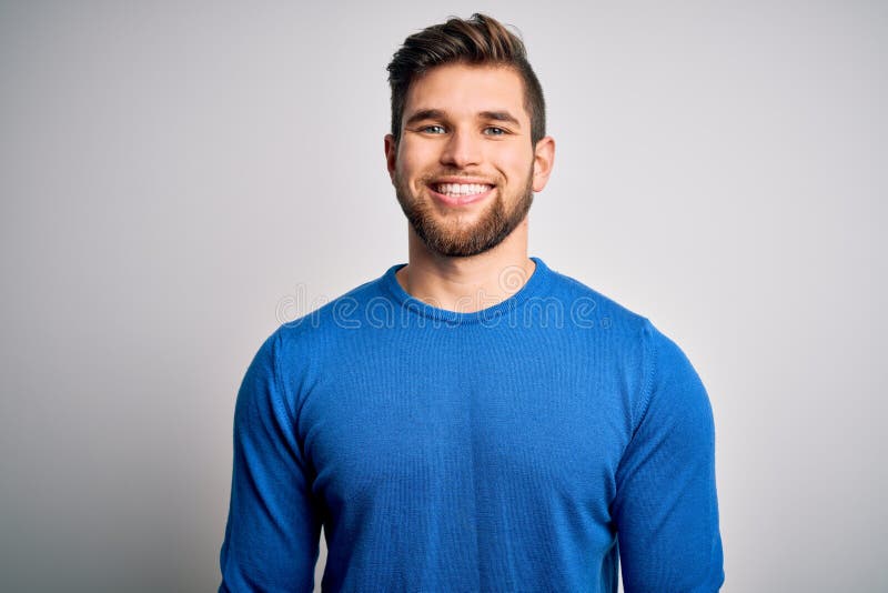 Young handsome blond man with beard and blue eyes wearing casual sweater with a happy and cool smile on face