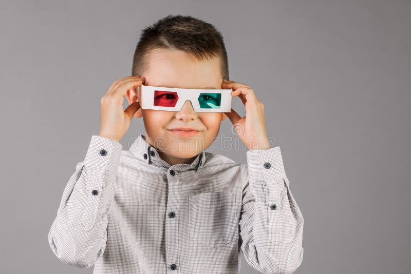 Young Handsome Boy with 3d Glasses on Grey Background in Studio Stock