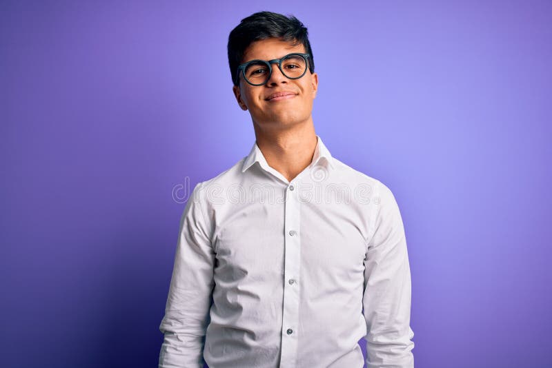Young handsome business man wearing shirt and glasses over isolated purple background Relaxed with serious expression on face