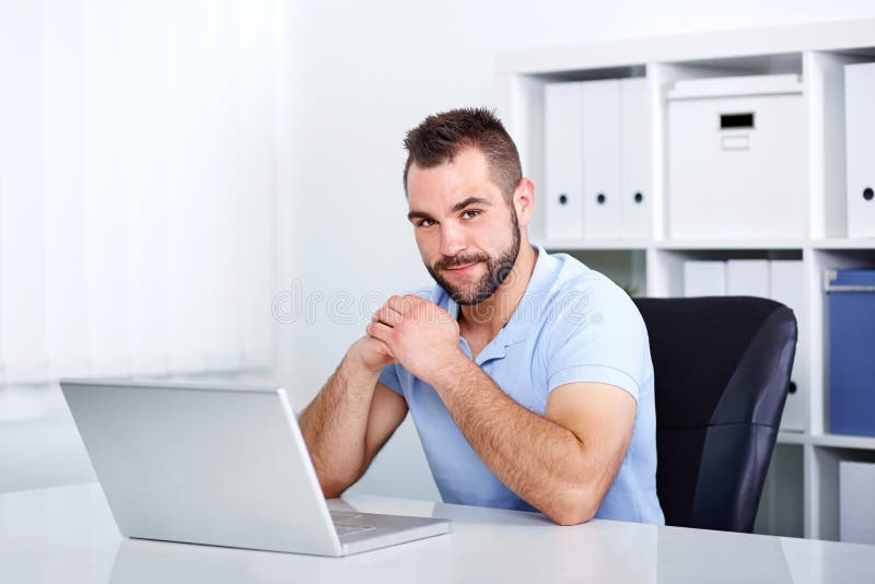 Young handsome business man working in the office royalty free stock photo Young handsome business man working in the office royalty free stock photo