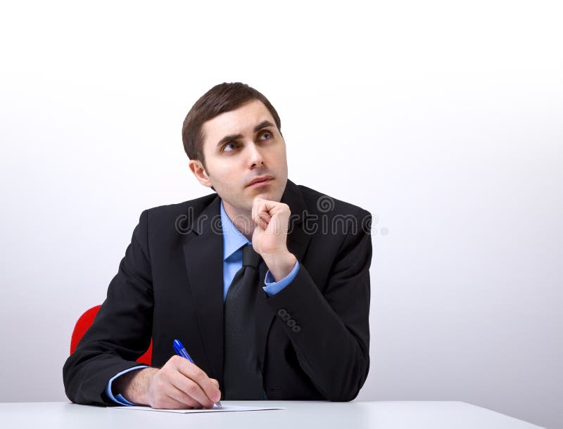 Young handsome businessman writing a letter royalty free stock image