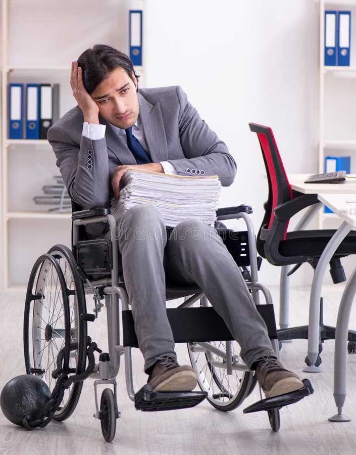 Young Handsome Employee in Wheelchair Working in the Office Stock Photo