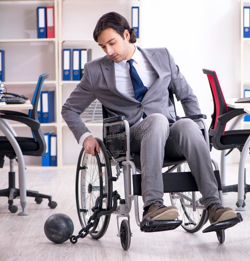 Young Handsome Employee in Wheelchair Working in the Office Stock Photo