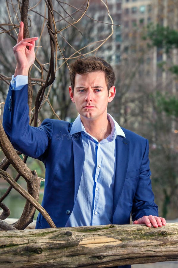 Young Man standing outdoors in winter, thinking stock photo