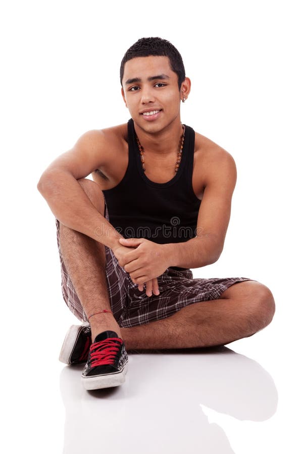 Young and handsome latin man, seated on floor