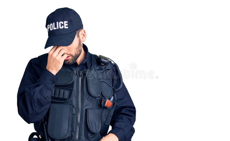 Young handsome man with beard wearing police uniform tired rubbing nose and eyes feeling fatigue and headache