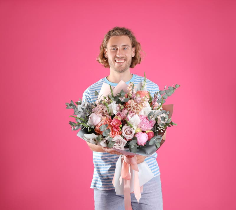 Young handsome man with beautiful flower bouquet stock images Young handsome man with beautiful flower bouquet stock images