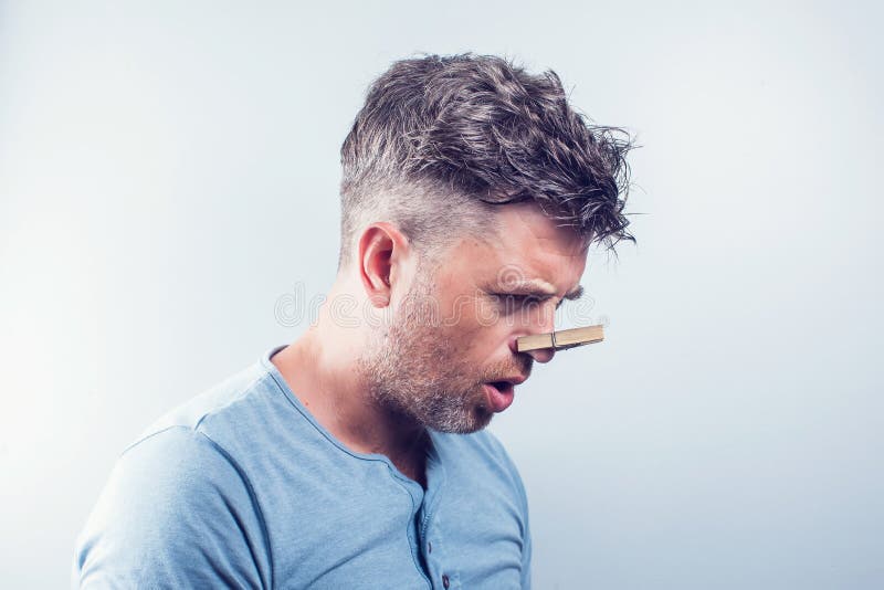 Young Handsome Man with Clothespin on His Nose. Allergy Stock Image