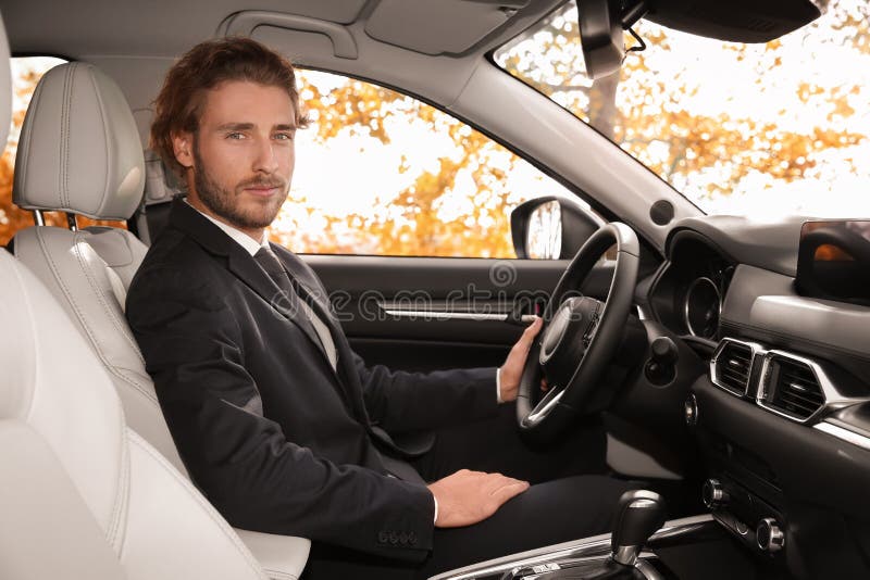 Young handsome man in driver`s seat stock photo Young handsome man in driver`s seat stock photo
