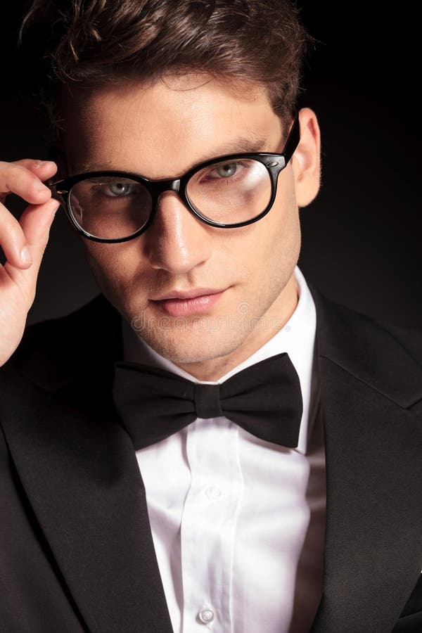 Young Handsome Man Fixing His Glasses. Stock Photo Image of people