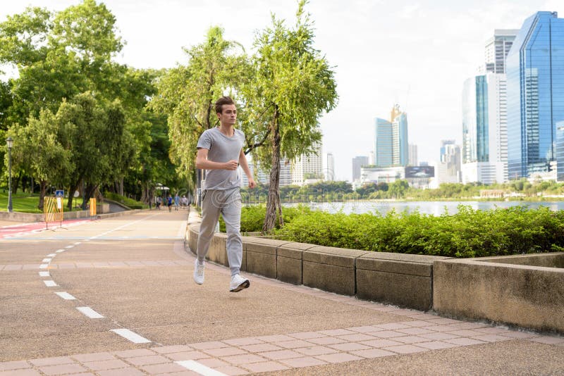 Young Handsome Man Jogging at the Park Stock Photo - Image of body ...