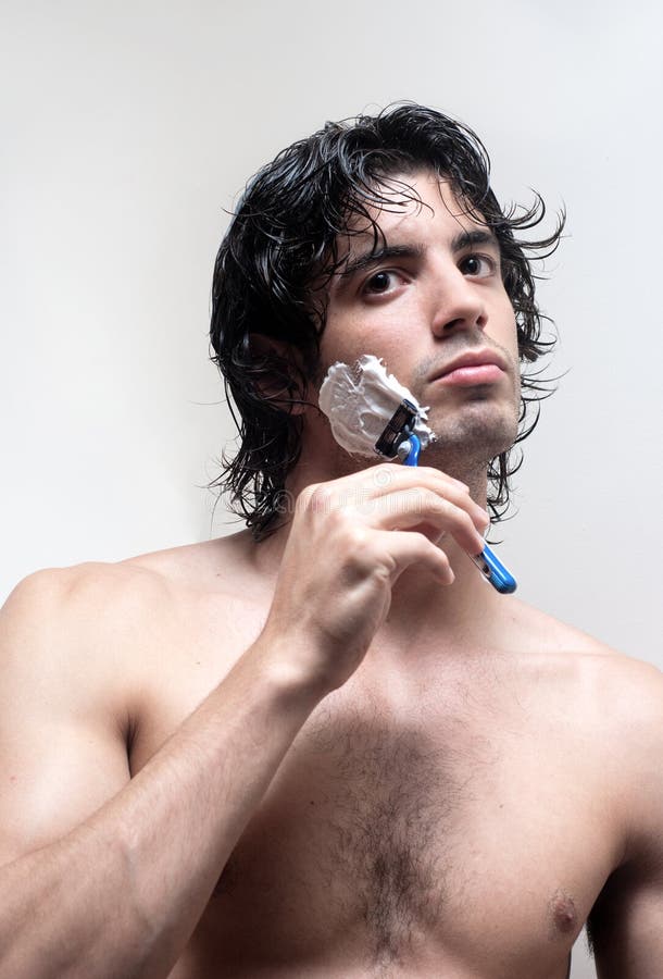 Young handsome man shaving stock photo Young handsome man shaving stock photo